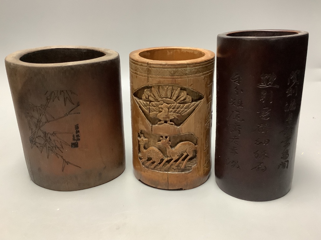 An assortment of Chinese carved bamboo and wood brush pots, tallest 17cm (8)